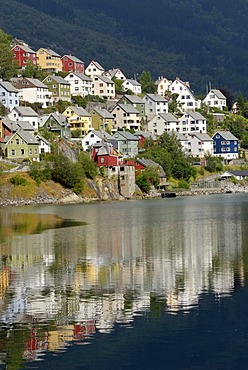 Houses reflecting in the water of the Sorfjord, Odda, province of Hordaland, Norway, Europe