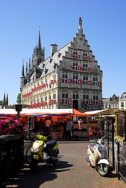 Two scooters, in the back the Stadhuis Gothic city hall on the market square of Gouda, Zuid-Holland, South Holland, the Netherlands, Europe