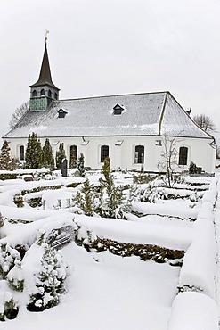 Snow covered graveyard and village church, Magleby, Denmark, Europe