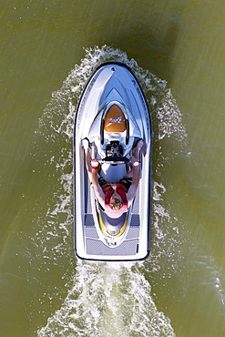 Young man on jet ski, from above