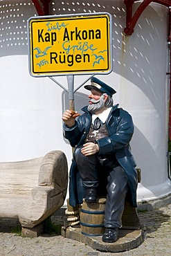 Seaman figure with a town name sign in front of the lighthouse at Cape Arkona, Isle of Ruegen, Mecklenburg-Western Pomerania, Germany, Europe