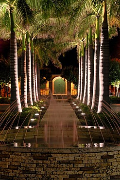 Illuminated Palm Avenue and fountain in front of the harbourmaster, Frederiksted, island of St. Croix, U.S. Virgin Islands, USA