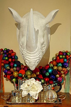 Colorful Christmas balls and a large plastic rhino head on a wall decorated for sale, Im Weller, Nuremberg, Middle Franconia, Bavaria, Germany, Europe