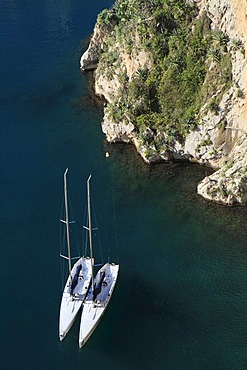 Two sailboats lying in the port of Fontvieille against the rocks of the old town, Principality of Monaco, the Cote d'Azur, Europe