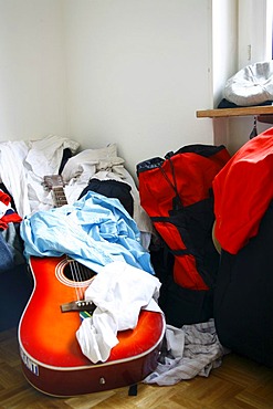 Messy room, student room with a guitar