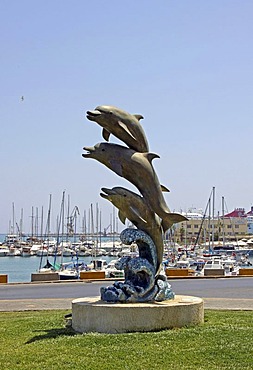 Dolphins, sculpture, Venetian harbour, yachts and fishing boats, Heraklion or Iraklion, Crete, Greece, Europe