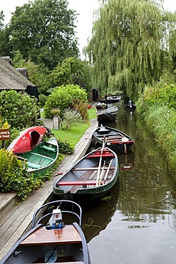 Parked boats on the canal along the Dutch properties, Giethoorn, Flevoland, Netherlands, Europe