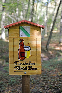 Sign on a hiking trail, shows the amount of time you need to walk off a beer