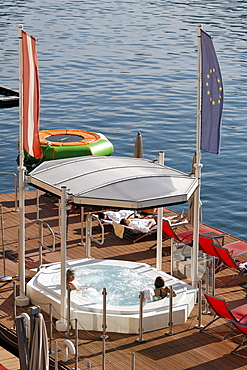 Roofed jacuzzi, pool and wellness platform in the Wolfgangsee lake, hotel Im Weissen Roessl, St. Wolfgang, Salzkammergut region, Upper Austria, Austria, Europe