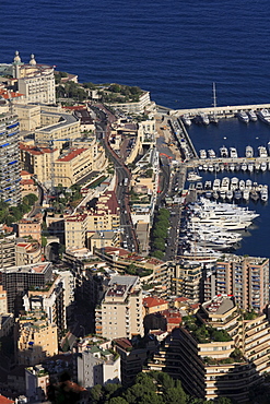 Monte Carlo district with the road leading up to the Casino, the start of the Formula 1 race track, top left, the Casino, and to the right the port of La Condamine with superyachts, Principality of Monaco, Cote d'Azur, Europe