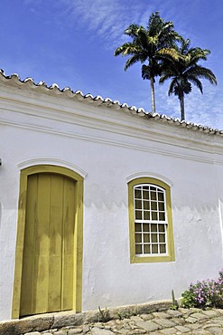 Palm trees behind facade in the historic city of Paraty, Parati, Rio de Janeiro, South America