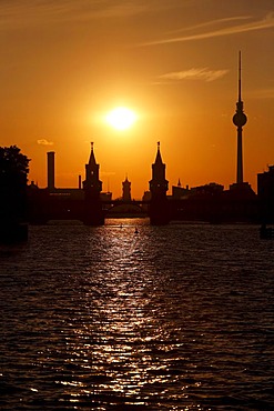 Sunset on the Spree River, bridge Oberbaumbruecke, Red Town Hall and Television Tower in Berlin, Germany