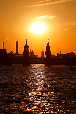 Silhouette of the Oberbaumbruecke bridge across the Spree river and Rotes Rathaus town hall at sunset in Berlin, Germany, Europe