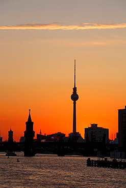 Silhouette of the Oberbaumbruecke bridge across the Spree river and Rotes Rathaus town hall at sunset in Berlin, Germany, Europe