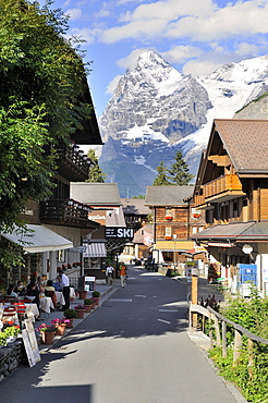 The main road of the car-free mountain village of Muerren, in the back Mt. Eiger, Canton Bern, Switzerland, Europe