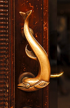 Dolphin as a decorative door handle on a commercial building, Hamburg, Germany, Europe