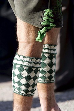 Man wearing so called Wadelwaermer, diamond-patterned woolen accessoire for keeping the calves warm, Bavarian costume, in Seehausen, Bavaria, Germany, Europe