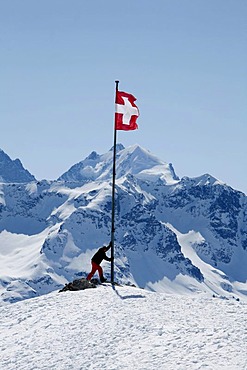 Swiss national flag and alpine sportspeople on the plateau Trais Fluors, St. Moritz, Oberengadin, Graubuenden, Switzerland