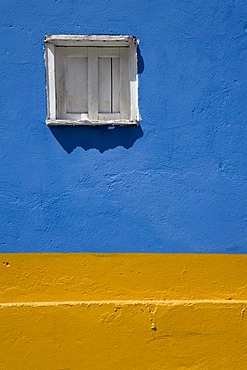 Wall painted in bright blue and yellow, wooden window, Santo Domingo, Venezuela, South America