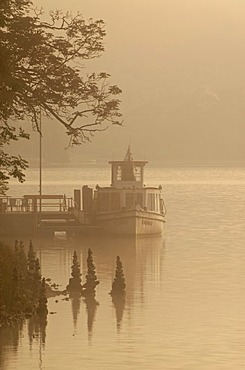 Morning fog and a ship in Grundlsee in northern Styria, Austria, Europe