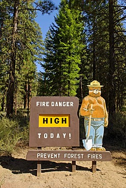 Smokey Bear on a High Fire Danger warning sign in the National Forest, Oregon, USA