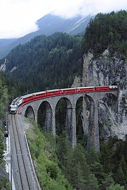 RhB, Rhaetian Railway train crossing the Landwasser Viaduct near Filisur, Albula section, Filisur, Graubuenden, Switzerland, Europe