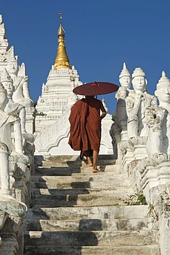 Settawya Pagoda, young Buddhist monk with a red umbrella, Mingun, Burma, Myanmar, South East Asia