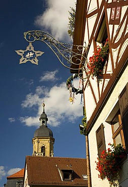 Guild sign on a hotel and the Basilica in Goessweinstein, Franconian Switzerland, Upper Franconia, Bavaria, Germany, Europe