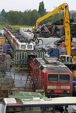 View of scrap yard, recycling yard, 9 E-locomotives, large gripper for junk, utilization of metal