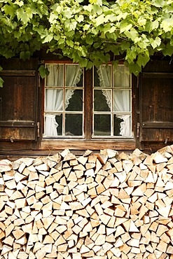 Old Bavarian farmhouse with wooden window shutters, firewood, Linderhof, Bavaria, Germany, Europe