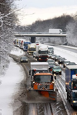 Snow plough in operation, traffic jam after heavy snow fall, motorway Autobahn A40, Ruhr expressway between Duisburg and Essen, near Muelheim, North Rhine-Westphalia, Germany, Europe