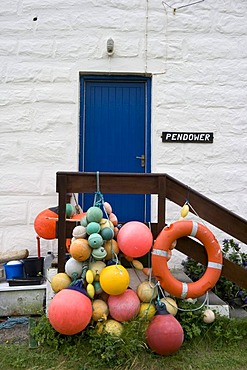 Net buoys and fenders in front of Pendower fishermans cottage, Porthgwarra, Cornwall, Great Britain, Europe