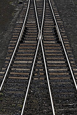 Railway tracks with a switch joining two tracks into one, view from above