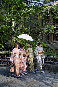 Japanese women wearing kimonos in the historic city centre of Kyoto, Japan, Asia