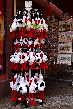 Plush or fluffy toy storks as souvenirs in Ribeauville, Alsace, France, Europe