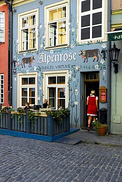 Alpenrose bar cafe restaurant terrace in the Jauniela street in the historic center Vecriga, mural painting with flowers and cows, Riga, Latvia, Baltic States, Northeast Europe