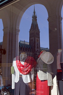 Fashion store in the arcades with woman's clothing and a reflection of the City Hall tower, Hamburg, Germany, Europe