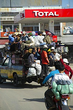 Crammed full pick up truck in front of a gas station at ferry station Neak Loeang, Cambodia, Southeast Asia