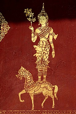 Gold color buddist figure on red background, Tempel Wat Saen, Luang, Prabang, Laos, South Asia