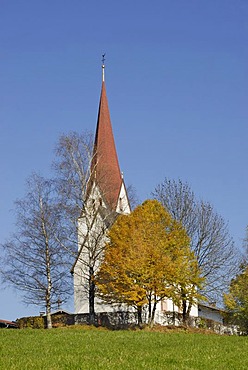 Romanic church on a hill, surrounded by autumnal trees, Kleinsoell, Tyrol, Austria, Europe