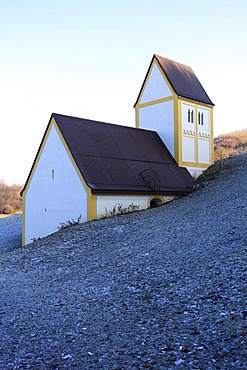 Artistic imitation of the disapperared village Froettmaning by the artist Timm Ulrich, partially buried replica of the Heilig Kreuz Church, art at the Allianz Arena, trash mountain, Freimann, Munich, Bavaria, Germany