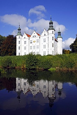Castle with reflection in the water, moated castle, city of Ahrensburg, Stormarn district, Schleswig-Holstein, Germany, Europe