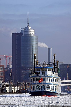 Paddle wheel steamer, Louisiana Star, in winter in the icy waters of the Elbe River in front of HafenCity with the Hanseatic Trade Centre, Hamburg harbour, Hamburg, Germany, Europe