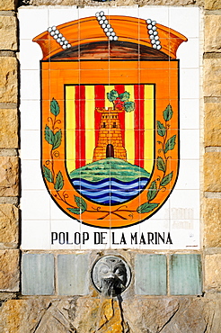 Fountain decorated with tiles painted with the coat of arms of Polop de la Marina, Alicante, Costa Blanca, Spain