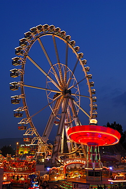 Ferris wheel and swing carousel at a fair in Stuttgart, Baden-Wuerttemberg, Germany, Europe