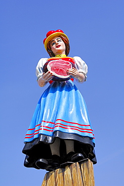 Traditional Black Forest girl sculpture at an annual fair