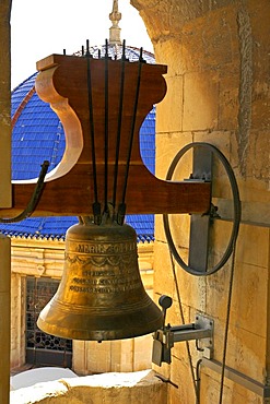 Church bell in the bell tower in front of blue ceramics dome of the baroque basilica from the 17th century, basilica Santa Maria, Elx, Elche, Costa Blanca, Spain