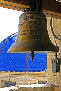 Church bell in the bell tower in front of blue ceramics dome of the baroque basilica from the 17th century, basilica Santa Maria, Elx, Elche, Costa Blanca, Spain