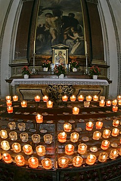 A side chapel with offering candles in the cathedral of Salzburg Austria