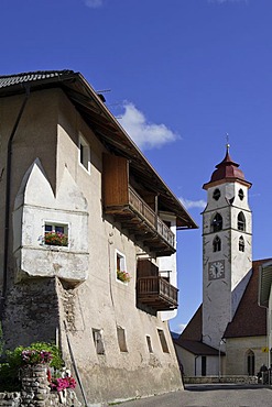 Old house and the church inaugurated to the saints of Ulrich and Wolfgang, Deutschnofen, Eggen valley, South Tyrol, Italy